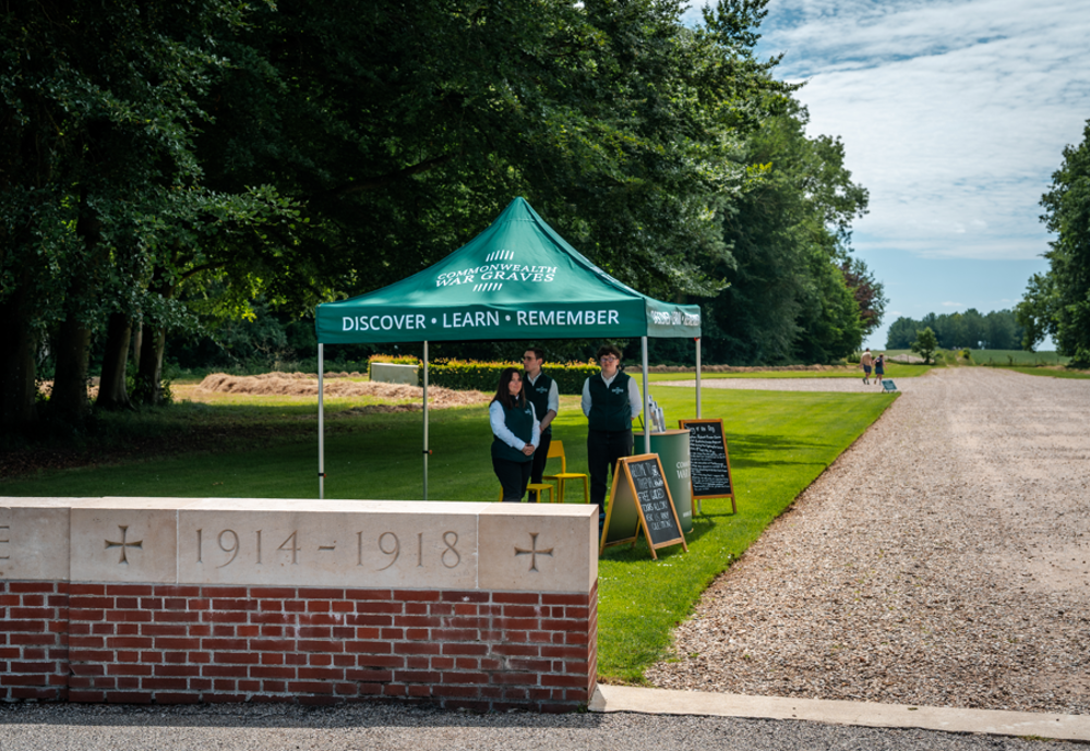 CWGF Guides under a gazebo at the entrance to a CWGC War Memorial,