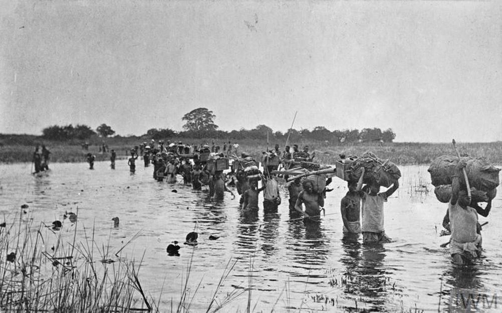 carriers transporting stores across the chambeshi river iwm collection zambia iwm q 103654